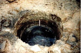 Data structure report plate 2: 'Barrel showing hoops after removal of staves looking NE', Archaeological excavation, St. Patrick's Church, Cowgate, Edinburgh