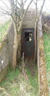 A sheet-metal door at the SE corner of the bomb store