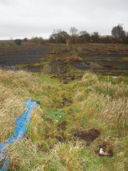 View SSE of the rails marking the location of the sliding doors at the ENE end of the more northerly pair of hangars (right)