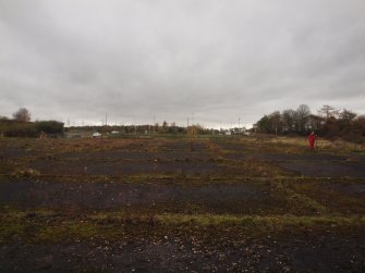 View WSW of the concrete apron representing the foundation of the most northerly hangar (Allan Kilpatrick surveying, left)