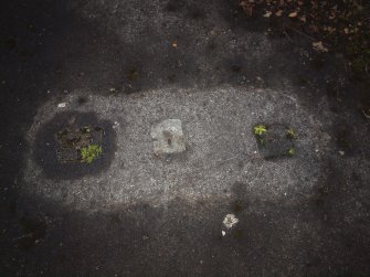 An octagon block which formerly held three tethering rings set in the floor of a hangar 