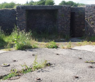 The holdfast in the NNE gun-pit from the ESE with an ammunition locker (behind) and the entrance to the crew shelter (right)