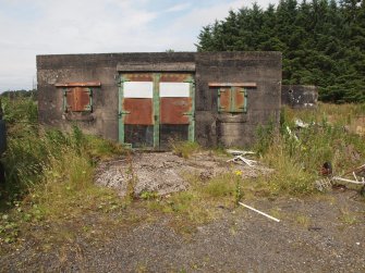 The entrance to the magazine attached to the NW gun-pit (NS 45132 57213) showing the original sheet metal shutters to the windows and the double doors
