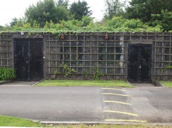 The original sheet metal double doors from the NE providing access to the weapons maintenance store, with the paired windows in between 