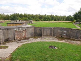 Three demolished ammunition lockers against the E wall in the SW gun-pit (NS 68150 59837) with the crew shelter behind the locker on the left 