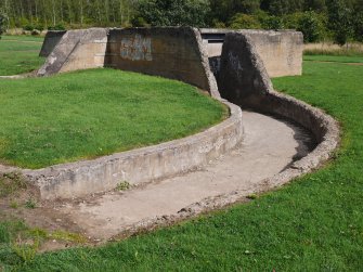 View from the W of the SW path and the reinforced concrete blast wall protecting the magazine that served the S and SE gun-pits 