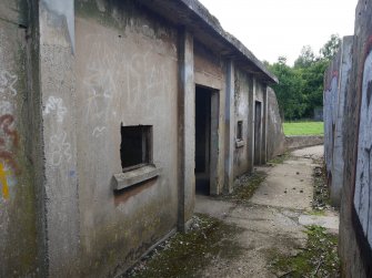 View from the NE of the path passing between the SE magazine façade and the blast wall