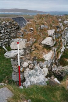 Historic building survey, Building No. 3, S wall interior, collapsed masonry and internal quoins at SW corner of primary building, facing NE, Cille-Bharra Church Group, Eoligarry, Barra