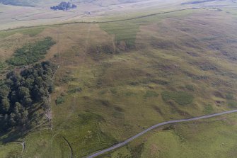 Oblique aerial view of Normangill 2 unenclosed platform settlement and cairnfield
