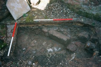 Archaeological evaluation, Test Pit 1 cobbled surface (103) and wall (105), 126-128 High Street, Dunbar