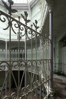 First floor. Octagonal hall detail of balcony railings showing cast iron columns and finials and wrought iron railings. 