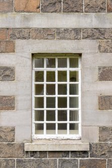 Detail of window on south east elevation at basement level with cast iron frame and astragals