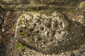 View of cup and ring marked stone below east window. Photographed with flash.