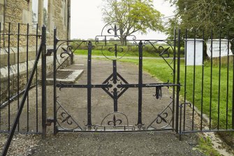 Detail of gate made from original church oil lamp brackets at south of church.