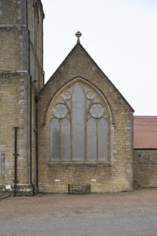 Detail of east traceried window and cross on gable above. 
