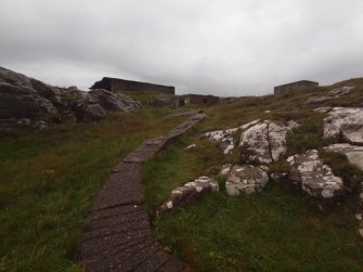 West Light: view S from the path leading down to the searchlight, with the W Gun Emplacement (NG89SW 4.01), the W Engine House (NG89SW 4.04) and the W Magazine in the background 