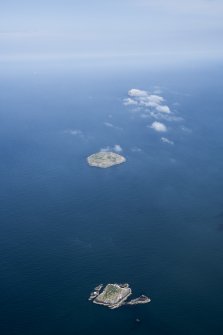 Oblique aerial view with Lamb Island in the foreground and Craigleith and Bass Rock beyond.