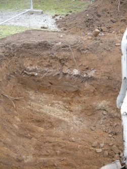 Watching Brief photograph, Pit to maximum depth showing buried topsoil. S section, Crathes Castle Stables