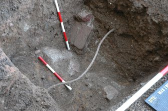 Evaluation photograph, Detail of trench looking NW, Scales indicate brick drain, Lightning conductor trench, Haddo House, Tarves