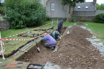 Excavation photograph, General views of people working, cobbles of pend being cleaned, St Drostan's Episcopal Church, Old Deer