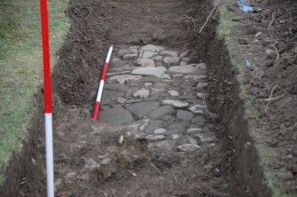 Excavation photograph, Details of cobbles 6 and wall 7, looking E,  St Drostan's Episcopal Church, Old Deer