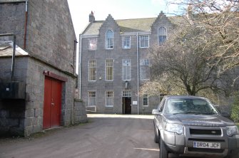 Survey photograph of New College, E wall of E wing, S end, boiler house to LHS, Blairs College and Estate