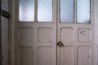 View of wooden panel doors in men's toilets