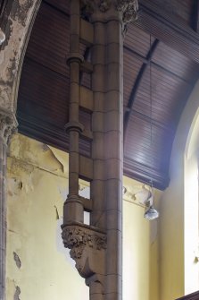 Detail of carved corbel and partially detached column in West gallery