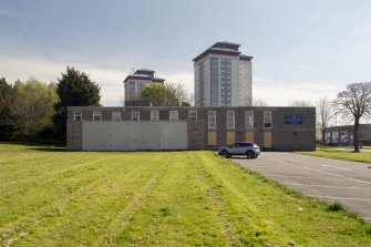 General view of church with Gallowhill Court and Glencairn Court tower blocks from west