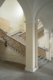 Ground floor View of main staircase, balustrade, pillars and vaulted corridor  looking east
