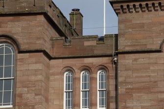 Detail of crenellations and arched windows on south face