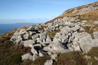 General view along the dyke showing one of the associated structures. View from SE.