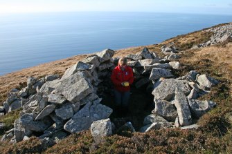 General view along the dyke showing Angela Gannon recording one of the associated subterranean structures (structure at NM 31223 98333)