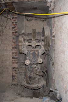 Interior. Sub-basement onto North Frederick Street. View of hydraulic rack slide control valve lit by flash light. Rack visible, centre. Rope wheel on right.
