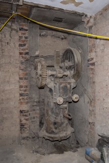 Interior. Sub-basement onto North Frederick Street. View of hydraulic rack slide control valve lit by flash light. Rack slide visible, centre and rope wheel on right.