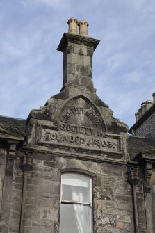 Detail of datestone in gable of former Co-op building at Nos 61-63 Main Street, Clackmannan, reading 'CO:OPERATIVE SOCIETY LD FOUNDED 1863'