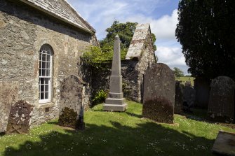 View of arched window, monument and burial aisle from southwest