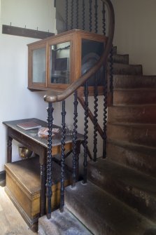 Tower entrance lobby. Detail of stairway, balustrade and cabinet containing pewter communion ware