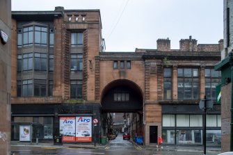 View of shop front and archway to Sauchiehall Lane from east