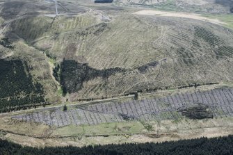 Oblique aerial view. This is one of a series of photographs of changing forestation patterns along the course of the M74 between Crawford and Kirkpatrick-Fleming.