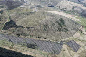 Oblique aerial view. This is one of a series of photographs of changing forestation patterns along the course of the M74 between Crawford and Kirkpatrick-Fleming.