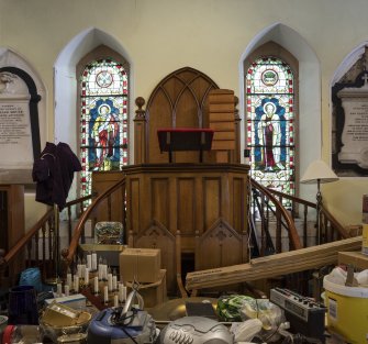 Ground floor interior.  View of pulpit with flanking stained glass windows in memory of John Ross and Sir Robert George Crookshank Hamilton  and Mouat Memorials.