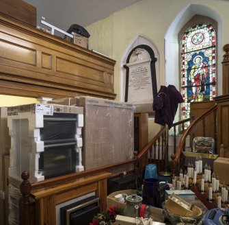 Ground floor interior.  View showing gallery,  William Mouat memorial plaque, St Peter stained glass window  and pulpit staircase.