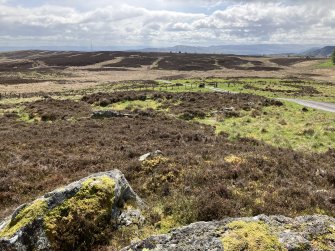 View of Hut Circles NO04NE 6.04 at NO 0764 4847 and NO04NE 6.01 at NO 0760 4844 from ENE