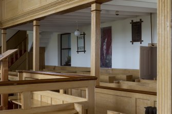 General view to north wall showing gallery pillars and pews