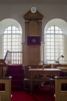 Detail of communion table, pulpit and arched south facing windows