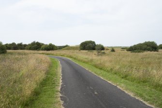 View across WW1 drying area with blast mounds of later WW2 explosives magazines visible