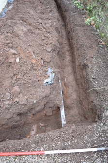 Watching Brief photograph, Trench showing ceramic water pipe at base of trench and blue modern water pipe 0.4m down, Knock Hill House, Glenbervie, Aberdeenshire