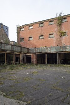 Courtyard View of cell block and south garage range from northeast