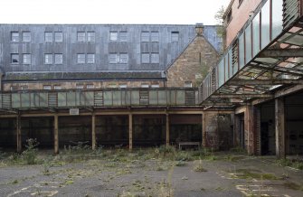 Courtyard View of south range garages and glazed canopy of cell block from north with 15-21 Steel Street beyond.